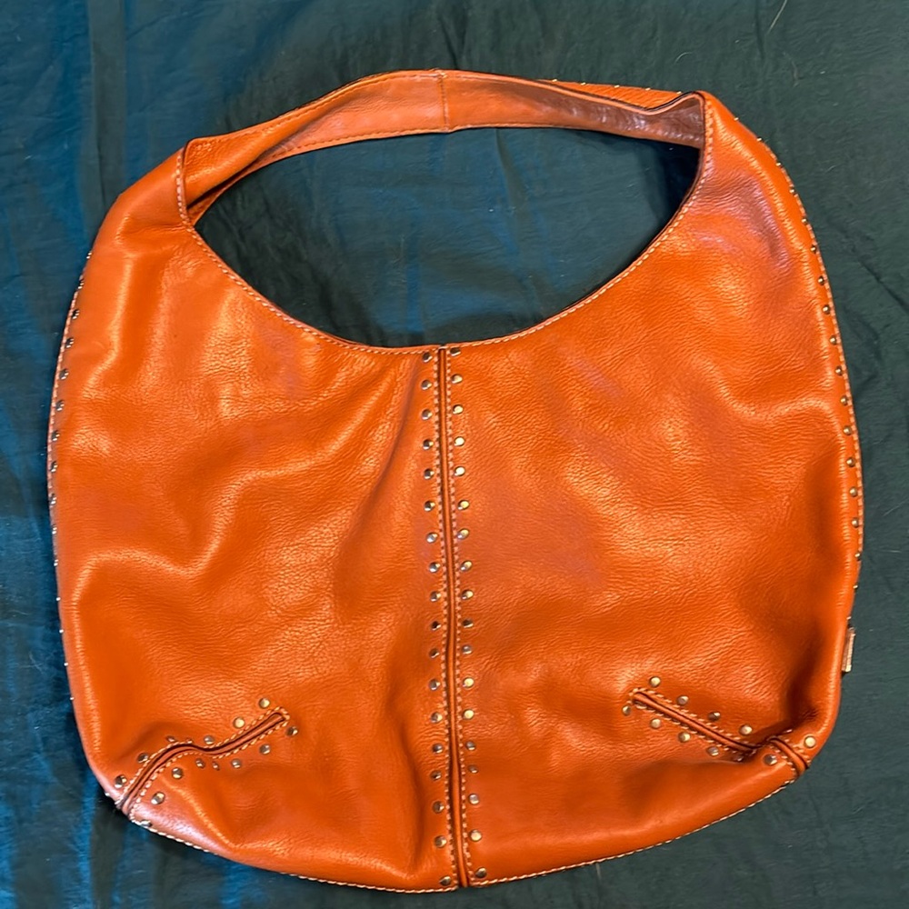 Michael Kors riveted hobo bag.  Brand new, never used.  Some scrapes as shown.